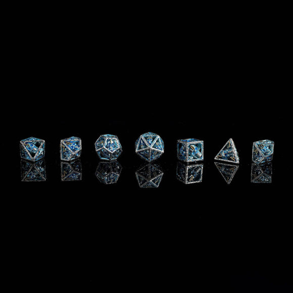 Skull's Grin Hollow Metal Dice Set - Glow in the Dark Blue - Bards & Cards