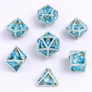 Skull's Grin Hollow Metal Dice Set - Glow in the Dark Blue - Bards & Cards